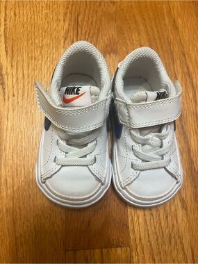 Nike Kids White Sneakers with Orange Swoosh and Blue Accents
